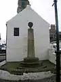 The Mercat cross at the 'jougs'