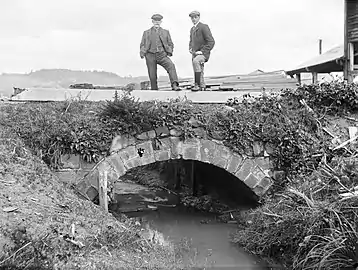 Kohukohu bridge around 1900 to 1920, with the timber mill visible in the background