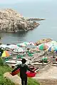 haenyeo carrying baskets toward the sea in Ulsan