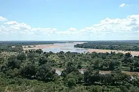 Taken from South Africa, to the left is Botswana and Zimbabwe is on the right. The river running from left to right is the Limpopo River. The river which disappears on the horizon is the Shashe