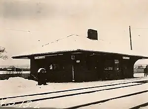 A small railway station covered with snow