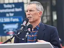 Paul Dolan speaking at a lectern