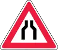 Road narrows on both sides