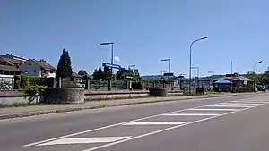 Station next to road with platforms