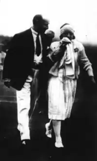 Lenglen walking off the court after retiring against Mallory alongside FFLT vice president Albert de Joannis