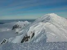 The twin peak of Sofia Peak and Great Needle Peak from Lyaskovets Peak, with Levski Peak in the foreground and Helmet Peak in the left background