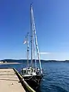 A sailboat docked at a pier in The Front