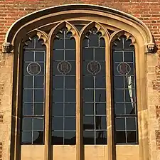 Tudor-style hood mould ending in decorative label stops (Magdalene College, University of Cambridge, England).