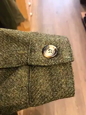 An example of the cuff of a tweed Teba, with the horn button variety.