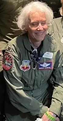 Marcelyn A. Atwood at the 2023 Women in Aviation International Conference, dressed in the last fight suit she wore on active duty, attending a "flight suit social".