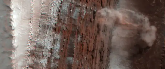 Dust clouds rise above the 700-metre (2,300 ft) deep cliff.