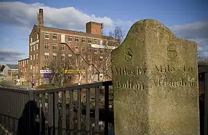 A milestone on Patricroft Bridge, along the Barton and Moses Gate turnpike road, near Eccles.  Note the older spelling of 'Altringham' - latterly Altrincham.