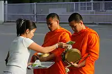 Monks receiving alms