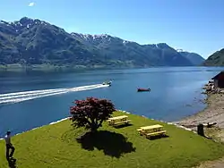 View of a small park in Nå, looking across the fjord