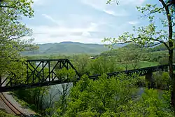 The James River is framed by crossing railway lines at Natural Bridge Station.