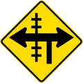 (W15-2/PW-13.2) Railway level crossing on controlled T-junction to left