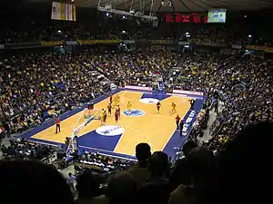 An indoor arena filled with people.