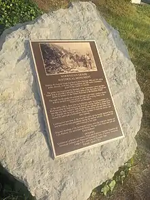 A bronze plaque, the text of which is included in the text of this wikipedia article.