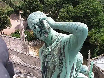 Statue of Thomas the Apostle, with the features of restorer Eugène Viollet-le-Duc, at the base of the flèche