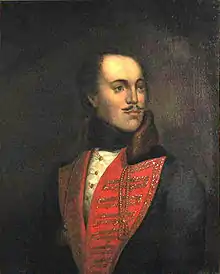 Picture of a painting of a man with a mustache wearing a red V collar; the man is slightly bald, and looking to his left.