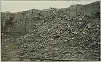 Photo of the original open-cast mine on Bell Island (c. 1900). The railway in the foreground was intended for mine carts.