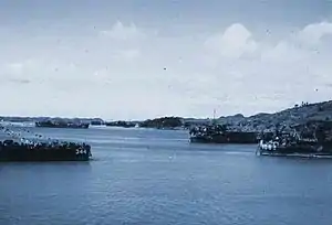 Left to right: LSM-344, LST-1074, and LST-1082 in Sasebo Harbor, Kyūshū, Japan. A Japanese seaplane base can be seen at the left center of photo.