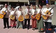 Photograph of male and female Filipino musicians holding their instruments