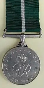 The obverse of the 1949 Pakistan Medal bearing the royal cypher of King George VI