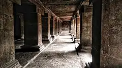 A passage with stone pillars inside the Pataleshwar temple