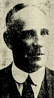 Black and white photo of a middle-aged man wearing a suit and tie