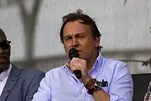 Philip Glenister speaking into a microphone