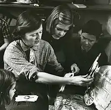 Fitzgerald shows her children paper dolls that her mother, Zelda, made for her.  From the February 1959 Life Magazine issue by Robert Phillips.