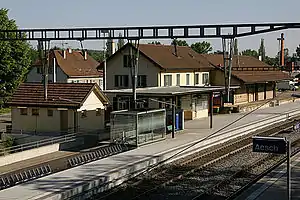 Two-story yellow station building with hip roof