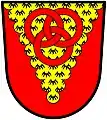 Mander (England): Gules, on a pile invected erminois three annulets interlaced two and one of the field.