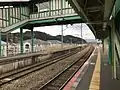 A view of the platforms and tracks looking in the direction of Keisen with close up of the footbrige.