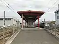 A view of the island platform. Note the Sugoca card reader and the waiting room.