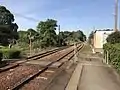 View of the platforms and tracks. Note the level crossing.