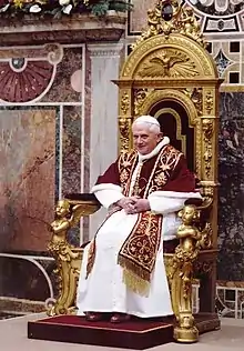 Pope Benedict XVI wearing the papal choir dress: papal mozzetta, rochet, white cassock, pectoral cross and a red embroided stole