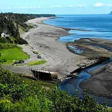 Beach at low tide in Port Greville, showing remnants of early port facilities