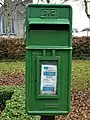 Irish Green postbox at Adare, County Limerick, with the P⁊Ꞇ logo