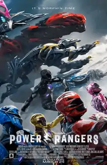 The five titular Power Rangers run into battle, with their respective large robotic Zords in behind them.