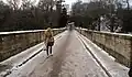 A pedestrian crosses Prebends Bridge in winter