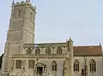 Stone building with square tower.