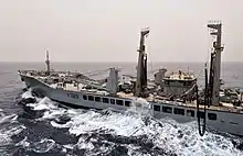 Wave Knight prepares to transfer fuel to the amphibious assault ship USS Bataan during a replenishment at sea.