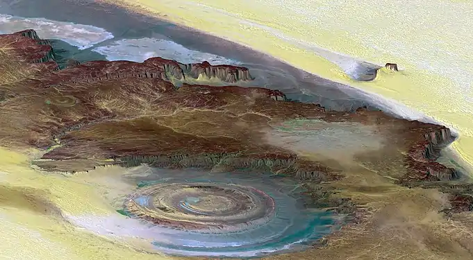 Image 72The Richat Structure is a depression in the country of Mauritania, almost 50 km (30 mi) across. It was originally thought to be the impact of a meteorite. Now  it is thought to be a symmetrical uplift (circular anticline or dome) that has been exposed to erosion. In this false-color photo, bedrock is brown, sand is yellow and white, vegetation is green, and salty sediments are blue. (Credit: Landsat 7.) (from Portal:Earth sciences/Selected pictures)