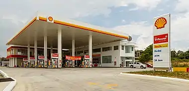 Image 19Filling stationPhotograph: Uwe AranasA filling station in Sabah, Malaysia, operated by Royal Dutch Shell. Filling stations, also known under a wide variety of names, are facilities that sell fuel and engine lubricants for motor vehicles. They include one or more fuel dispensers, which distribute fuels such as gasoline and diesel into the tanks within vehicles and calculate the financial cost of the fuel transferred. Filling stations may also include air compressors and electricity sockets, which may inflate tyres or offer charging stations. Many filling stations also incorporate a convenience store, where customers can purchase snacks and other goods.More selected pictures