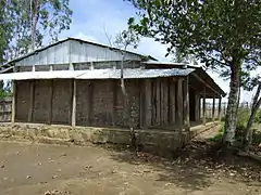 One-room schoolhouse with woven bamboo walls and corrugated tin roof