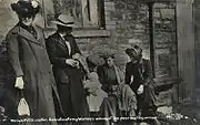 A female Salvation Army officer comforts a family