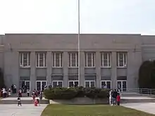 Exterior of the Sheboygan Municipal Auditorium and Armory during the day, with people outside