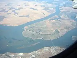 A photo of multiple strange-shaped islands covered in farmland. West Island isn't, though -- it's covered in vegetation.